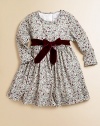 Blooming with a vivid floral print and a velvet tie, this delightful cotton frock will make your little one feel like a flower girl.Ruffled round necklineLong sleevesBack buttonsWaistband with velvet ribbon tieFull skirtFully linedCottonMachine washImported Please note: Number of buttons may vary depending on size ordered. 