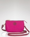 A stacked logo dresses up this understated Tory Burch handbag, styled for wear-with-all ease. A top zip secures the essentials, while a slim strap slides comfortably across the body.