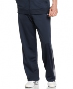Warm up and cool down in the sleek sporty comfort of these fleece-lined go-to track pants from adidas.