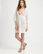 A gorgeous crochet coverup with a feminine self-tie neckline.Deep v-necklineThree-quarter sleevesSelf-tie frontCord endsElasticized waistCottonDry cleanMade in USA of imported fabric