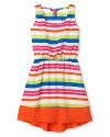 Her summer dress gets a makeover in wild neon stripes and bold colorblock.