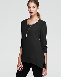 A layered hem and edgy side slits are the chic details that add greater depth to this silk Gold Hawk top. A layered hem and edgy side slits are the chic details that add greater depth to this silk Gold Hawk top.