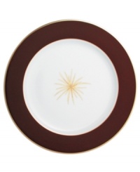 A rich burgundy rim frames a single gold starburst in the center of this striking service plate from Bernardaud. A rich burgundy rim frames a single gold starburst in the center of this striking service plate from Bernardaud.