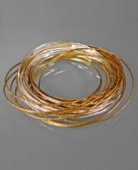 Make a jangling beat with this cluster of rich dual-toned bangle bracelets, from Jessica Simpson. In two-toned mixed metal. Each measures approximately 2-1/2 inches in diameter. Make a jangling beat with this cluster of rich dual-toned bangle bracelets, from Jessica Simpson. In two-toned mixed metal. Each measures approximately 2-1/2 inches in diameter.