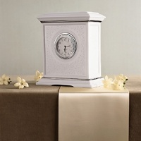 This elegant clock symbolizes how precious a couple's time together is. In porcelain adorned with pearl-like accents and touches of platinum. Crafted of Lenox fine porcelain accented with precious platinum. Height: 7Width: 5 3/4 This elegant clock symbolizes how precious a couple's time together is. In porcelain adorned with pearl-like accents and touches of platinum. Crafted of Lenox fine porcelain accented with precious platinum. Height: 7Width: 5 3/4