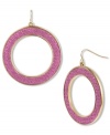 Girly sparkle is always a must. Betsey Johnson's fierce hoop earrings feature a dusting of fuchsia glitter for a flirty look. Set in gold tone mixed metal. Approximate drop: 2-1/2 inches. Approximate diameter: 2 inches.