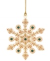 A traditional snowflake gets a makeover in this beautiful ornament from Lenox. Features an ornate gold design with emerald accents for a touch of glimmer. With gold hanging thread.
