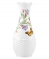 Crafted of elegant white porcelain, this Lenox bud vase combines the beloved Butterfly Meadow motif with a scalloped edge and textured accents for a look of country charm.