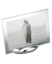 Keep memories fresh in the modern Elbow picture frame. A sculpted metal base turns back in an elegant curve, fitted with sheets of clear glass for displaying any photo, vertical or horizontal. Designed by Neil Cohen for Nambe. Keep memories fresh in the modern Elbow picture frame. A sculpted metal base turns back in an elegant curve, fitted with sheets of clear glass for displaying any photo, vertical or horizontal. Designed by Neil Cohen for Nambe.
