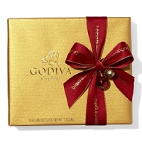 A classic assortment of Belgian chocolates from Godiva comes in a beautiful gold box tied with big red bow and holiday pick. Each ballotin includes Godiva signature favorite ganaches, pralines, caramels, fruits and nuts in milk, dark and white chocolate. A classic assortment of Belgian chocolates from Godiva comes in a beautiful gold box tied with big red bow and holiday pick. Each ballotin includes Godiva signature favorite ganaches, pralines, caramels, fruits and nuts in milk, dark and white chocolate.