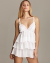 Exude elegance in this chiffon babydoll with delicate floral accents and tiered ruffle skirt.