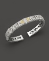 Sterling silver cuff set with faceted white sapphires set in 18K gold. By Judith Ripka.