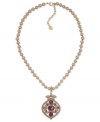 Glass pearls add elegance, ruby-colored accents add an edge in this pendant necklace from Carolee. The pendant, crafted from gold-tone mixed metal, gives a classic look an update. Approximate length: 16 inches. Approximate drop: 1-3/4 inches.