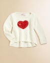 A cute, cozy knit gets a lovely update with a bold heart appliqué.Round necklineLong sleevesPullover styleHi-lo hemRayon/CottonHand washImported