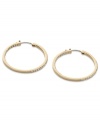 These timeless hoop earrings from Fossil get a glitzy upgrade with black diamond crystal accents. Crafted in shiny gold tone mixed metal. Approximate diameter: 1-3/8 inches.