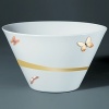 For over two centuries Raynaud has created unique Limoges porcelain, with a marked preference for relief shapes and generously colored and gilt decorations. Metamorphoses is a striking pattern of red and gold with a butterfly motif.