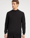 A sophisticated layer with a ribbed mockneck collar in soft merino wool.Ribbed mockneck collarLong sleeves with ribbed cuffsRibbed hemMerino woolDry cleanImported