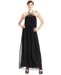 Vince Camuto's halter gown gleams with a shimmering paillette embellishment at the neckline and an effortlessly sophisticated silhouette. A pleated blouson-style bodice balances structure with a breezy fit. Vince Camuto's halter gown gleams with a shimmering paillette embellishment at the neckline and an effortlessly sophisticated silhouette. A pleated blouson-style bodice balances structure with a breezy fit.