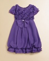 She'll be the center of your attention in this frilly, flouncy chiffon dress with rosette bodice, bubble skirt and bow with diamonte detail.Round necklineShort flutter sleevesBack zipperWaistband with bow and back sashRuffled hemPolyesterDry cleanImported