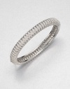 Neat rows of shimmering crystal line up along a slender bangle to wear alone or stack with others.CrystalRhodium platingDiameter, about 2.25Hinged with tongue-and-groove claspImported