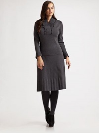 This pretty style featured a ruffled, pleated v-neck and pleated cuffs. Ruffled, pleated v-neck Long sleeves with pleated cuffs Pull-on style Wool Dry clean Made in Italy This pretty style featured a ruffled, pleated v-neck and pleated cuffs. Ruffled, pleated v-neck Long sleeves with pleated cuffs Pull-on style Wool Dry clean Made in Italy