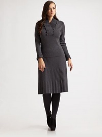 This pretty style featured a ruffled, pleated v-neck and pleated cuffs. Ruffled, pleated v-neck Long sleeves with pleated cuffs Pull-on style Wool Dry clean Made in Italy 