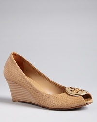 Tory Burch's Sally style is popular for good reason, with great looks and iconic logo hardware on wearable wedge heels. Tory Burch's Sally style is popular for good reason, with great looks and iconic logo hardware on wearable wedge heels.