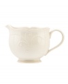 With fanciful beading and a feminine edge, this Lenox French Perle sauce pitcher is a great addition to your white dinnerware and has an irresistibly old-fashioned sensibility. Hardwearing stoneware is dishwasher safe and, in a soft white hue with antiqued trim, a graceful addition to every meal.
