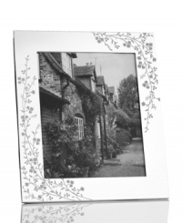 Etched with cascading florals, the silver-plated Trousseau picture frame from Martha Stewart Collection presents wedding photos and other sentimental moments with fresh elegance. With velvet backing. Etched with cascading florals, the silver-plated Trousseau picture frame from Martha Stewart Collection presents wedding photos and other sentimental moments with fresh elegance. With velvet backing.