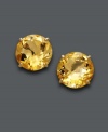 A burst of sunshine. Earrings feature round-cut citrine (6-1/3 ct. t.w.) set in 14k gold. Approximate diameter: 1/2 inch.