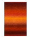 Imparting warm visions of brilliant sunrises on the horizon, this deeply textured rug features intense tones of red and orange that recall a perfect morning sky. Hand-tufted and color blended with the greatest of care, this wool rug comes alive with texture and color.