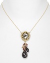 A bold, bejeweled cluster of stones, crystals, and pearls adorns this Alexis Bittar necklace, cast in gold plated metal.