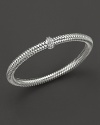 A row of diamonds binds this woven 18K white gold bracelet from Roberto Coin.