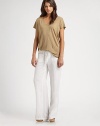 Equipped with asymmetrical draping and downtown-cool dropped shoulders, this comfortable v-neck is bound to be your new casual go-to. Rounded v-neckDropped shouldersShort sleevesLonger length hits below the hipsLinenHand washImportedModel shown is 5'10 (177cm) wearing US size Small.