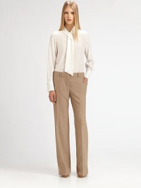 The epitome of minimal elegance: supple silk, tailored with a soft scarf neckline.Scarf tie necklineButton frontLong sleeves with button cuffsAbout 26 from shoulder to hemSilkDry cleanMade in France of imported fabricModel shown is 5'10 (177cm) wearing US size 4. The epitome of minimal elegance: supple silk, tailored with a soft scarf neckline.Scarf tie necklineButton frontLong sleeves with button cuffsAbout 26 from shoulder to hemSilkDry cleanMade in France of imported fabricModel shown is 5'10 (177cm) wearing US size 4.