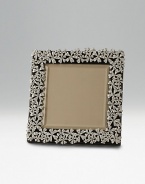 Polished and platinum-plated with ornate garland design. Leather back Arrives handsomely gift boxed