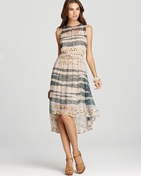 An abstract print lends an artsy sensibility to this Sam & Lavi dress, cut with a flowing high/low hem. An abstract print lends an artsy sensibility to this Sam & Lavi dress, cut with a flowing high/low hem.