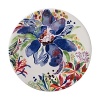 An opulent blue flower blooms from a backdrop of garden delights on the fresh, fun Eden dessert plate from Gien France.