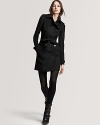 Burberry London's military-inspired coat flaunts a belted waist for a sleek, slimming silhouette.