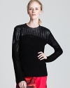 Foil-dipped, Edun's coated wool sweater flaunts downtown cool. Pair with a brightly hued skirt for chic contrast.
