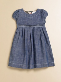 A captivating frock in soft chambray, with a crisply pleated Empire waist and sweet puffed sleeves.Round neckline with topstitchingShort puffed sleevesEmpire waist with stitched pleatsFull button back with check trimCottonMachine washImported Please note: Number of buttons may vary depending on size ordered. 