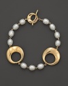 14K yellow gold links and hoops mingle with cultured freshwater pearls. Decorative toggle clasp.