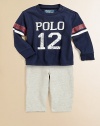 A sporty set pairs an essential fleece pant and an athletic cotton jersey tee with a faded graphic print. Tee CrewneckLong sleevesShoulder snaps Pants Front button closureRear elasticized waistbandFaux flyOn-seam pockets87% cotton/13% polyesterMachine washImported Please note: Number of snaps may vary depending on size ordered. 
