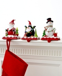 A stocking full of personality. Topped with a clay figurine of a penguin, Santa or snowman, these too-cute stocking holders keep gifts hanging, balancing the weight on a cast iron base. A stocking full of personality. Topped with a clay figurine of a penguin, Santa or snowman, these too-cute stocking holders keep gifts hanging, balancing the weight on a cast iron base.