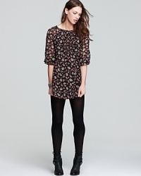 Cut in an abbreviated silhouette, this Free People mini dress flaunts a pretty floral print. Wear it on balmy evenings with metallic sandals and chilly days with opaque tights and booties. Cut in an abbreviated silhouette, this Free People mini dress flaunts a pretty floral print. Wear it on balmy evenings with metallic sandals and chilly days with opaque tights and booties.