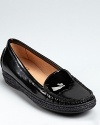 The loafer reinvented--Stuart Weitzman puts a stylish spin on the classic shoe, dressing it up in glossy patent leather with a unique braided trim around the sole.