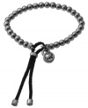 Polished beads add glamour and edge. Michael Kors' trendy wrap bracelet features hematite tone beads with a black leather closure and MK logo charm. Bracelet stretches to fit wrist. Approximate diameter: 2-1/2 inches.