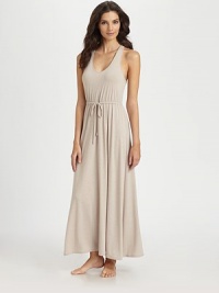 A figure-flattering silhouette of softly draped jersey fabric, with an unexpected sexy cross-over back. V-neckSleevelessRuched drawstring waistA-lineCrossed back with keyholeAbout 52 from shoulder to hem62% polyester/33% rayon/5% spandexMachine washImported A figure-flattering silhouette of softly draped jersey fabric, with an unexpected sexy cross-over back. V-neckSleevelessRuched drawstring waistA-lineCrossed back with keyholeAbout 52 from shoulder to hem62% polyester/33% rayon/5% spandexMachine washImported