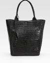 Luxurious croc-skin crafted in a roomy carryall and finished with leaf cut-out tassels.Double top handles, 8 drop Magnetic closure One inside zip pocket One cell phone pocket Suede lining 12W X 14½H X 5½D Imported