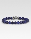 Rugged, lightly-textured lapis beads stand in stark contrast to the bracelet's hand-forged, sterling silver clasp. Beads, 8mm Length, about 8½ Lobster clasp Made in USA 